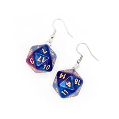 pair of blue and gold dice earrings with numbers on each side, set against a white background