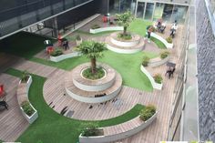 an aerial view of a courtyard with benches and plants