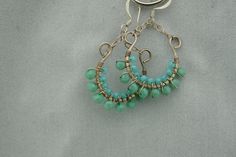 This is the perfect option for those who like cool, unique jewelry and the luxury, shine of sterling silver, turquoise. These earrings is well made, cute and/or elegant in design, and very desirable. The earrings have a drop part. The drop part has the shape of the semicircle on chains. The earrings are decorated with balls from turquoise. The clasp is in very good working condition. ♥ Age/Era: Circa before the 2000s. ♥ There is no hallmark, but it is sterling .925.(tested with acid). ♥ The earr Elegant Turquoise Hypoallergenic Hoop Earrings, Turquoise Dangle Hoop Earrings Wire Wrapped, Handmade Turquoise Hoop Earrings As Gift, Nickel-free Green Sterling Silver Hoop Earrings, Turquoise Hoop Earrings As A Gift, Turquoise Sterling Silver Hoop Earrings For Pierced Ears, Turquoise Wire Wrapped Dangle Hoop Earrings, Turquoise Wire Wrapped Hoop Earrings Gift, Turquoise Hoop Earrings For Gift