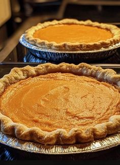 two pies sitting on top of metal pans