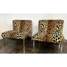 pair of leopard print chairs with chrome legs