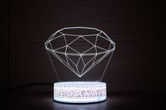 a diamond shaped light sitting on top of a table