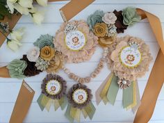 flowers and ribbons are arranged on the table for a baby shower party or first birthday