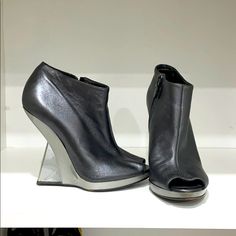 Metallic Gray Salvatore Ferragamo Open Toe Booties With A Pvc Heel Designer Leather Boots For Spring, Luxury Closed Toe Boots For Spring, Designer Spring Boots With Leather Sole, Designer Round Toe Leather Heels, Designer Ankle-high Heels With Leather Sole, Chic Leather Open Toe Booties, Modern Closed Toe Spring Boots, Modern Closed Toe Boots For Spring, Formal Open Toe Leather Boots