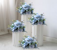 three white columns with blue flowers on them