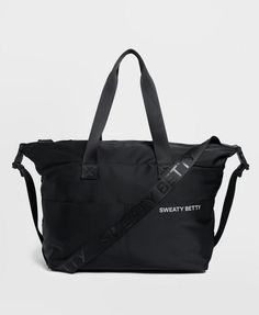 a black tote bag with the words sweaty betty on it's side