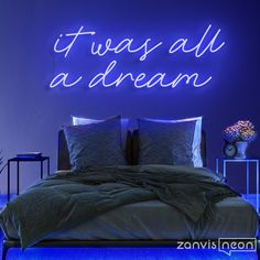 there is a neon sign that says it was all a dream on the wall above the bed