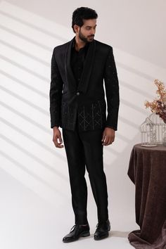 Black double lapel collar tuxedo with sequin and cutdana embroidery. Paired with a black shirt and pant.
Components: 3
Pattern: Embroidered
Type Of Work: Sequin, Cutdana
Neckline: Lapel collar
Sleeve Type: Long
Fabric: Terriwool and Cotton, Lining: Poly
Color: Black
Other Details: 
Attached poly lining
Approx. product weight: 3 kgs
Occasion: Cocktail and Reception - Aza Fashions Luxury Lapel Collar Suits For Party, Luxury Party Suits With Lapel Collar, Designer Tailored Blazer For Party, Black Winter Party Suits, Winter Party Sets With Suit Collar, Designer Blazer With Suit Collar For Party, Embellished Notch Lapel Suits For Semi-formal Occasions, Designer Party Blazer With Suit Collar, Tailored Embellished Sets For Party