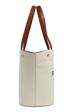 Unbleached canvas made of cotton and linen furthers the casual, go-everywhere appeal of this shapely tote fronted by bold logo lettering. Open top Top carry handles; removable, adjustable crossbody strap Structured silhouette with flat base for stability Textile with leather trim Made in Italy Designer Handbags Beige Logo Bag For Summer, Chic Bags With Embroidered Logo For Everyday Use, Beige Shoulder Bag With Embroidered Logo For Everyday Use, Canvas-lined Cotton Bucket Bag, Large Capacity Bucket Canvas Bag, White Cotton Canvas Bag With Leather Handles, Chic Everyday Bag With Embroidered Logo, Cotton Canvas Bucket Bag With Canvas Lining, Shopping Bag With Embroidered Logo In Coated Canvas