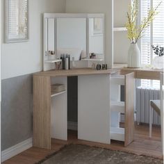 a white and wood vanity with mirror, stool and vase