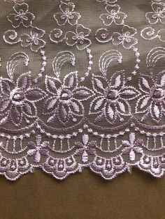 an embroidered lace with flowers on it