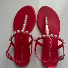 Stuart Weitzman Red Jelly Sandals With Pearl Detail. Size 37.5 / 7. Perfect Condition, Never Worn. Elegant Flat Heel Sandals With Red Sole, Flat Sandals With Red Sole For Party, Red Flat Heel Sandals For Evening, Party Sandals With Red Sole And Flat Heel, Red Jelly Sandals For Spring Party, Designer Red Sandals For The Beach, Red Round Toe Jelly Sandals For Vacation, Red Open Toe Jelly Sandals For Party, Red Jelly Sandals For Summer Party