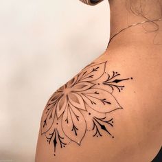 a woman with a tattoo on her shoulder