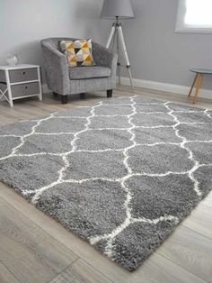 a living room with a gray chair and rug