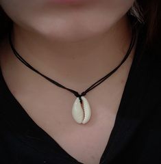 COWRIE SHELL NECKLACE natural cowrie seashell on an adjustable 1mm waxed cotton cord necklace How to adjust your necklace Place fingers on the knots either side of the pendant & pull knots away from pendant to loosen the necklace. Once placed over your head, pull the knots back towards the pendant to tighten to desired length! Measurements: Our necklaces are designed to be fully adjustable, and can be worn as a loose fitting choker down to a long necklace (one size fits all!) Pendant = appro Shell Jewelry With Adjustable Cord As Gift, Shell-shaped Jewelry With Adjustable Cord As Gift, Adjustable Shell-shaped Jewelry Cord As A Gift, Shell With Adjustable Cord For Gift, Adjustable Shell Choker Gift, Adjustable Cord Shell Necklace For Gifts, Adjustable Shell Choker As Gift, Adjustable Shell Choker For Gift, Adjustable Strand Choker For Gift