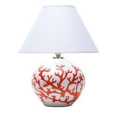 a red coral lamp with a white shade