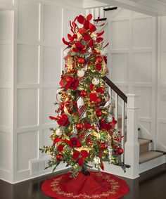 a christmas tree decorated with red and gold ornaments