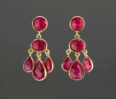 An exquisite piece of art work, this pair of three-tier genuine ruby earrings would be nice reward for yourself or a great gift for your mother or best friend. Each one has three layers of natural ruby stones set in leaflet shaped, gold plated bezels and laid in a dangling willow branch pattern. 1. Stones : ruby (natural gemstone) 2. Stone shape and size:      top tier: a bezeled round ruby 10mm     middle tier: a bezeled oval ruby 14 x 10 mm     bottom tier: three dangling pear shaped ruby 14 x 11 mm center; 10 x 8 mm two sides 3. earring total length/width ~ 40 mm/19 mm 4. bezel material: 24k gold vermail 5. earring post: 24k gold vermail 6. if sending as a gift, a personalized note card can be included Earrings in other colors/stones are available. Please browse my other earring listing Exquisite Red Ruby Earrings, Exquisite Ruby Red Earrings, Red Chandelier Earrings As Gift, Red Ruby Dangle Chandelier Earrings, Elegant Ruby Chandelier Dangle Earrings, Ruby Drop Chandelier Earrings As Gift, Handmade Ruby Earrings For Anniversary, Red Chandelier Earrings For Anniversary, Handmade Ruby Dangle Earrings