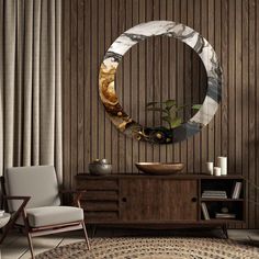 a living room with a round mirror on the wall next to a chair and table