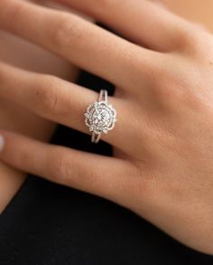 a woman's hand with a diamond ring on it