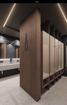 a bathroom with several stalls and sinks in the middle, all made out of wood