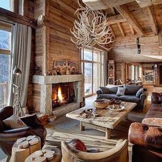 a living room filled with furniture and a fire place in the middle of a room