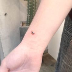 a small watermelon tattoo on the left inner wrist is shown in front of a cactus