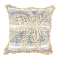 a blue and white pillow with fringes on the front, palm tree design in beige