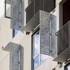 an apartment building with metal balconies hanging from the side of it's windows