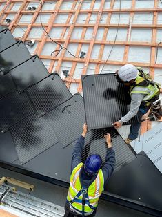 two men working on the roof of a building