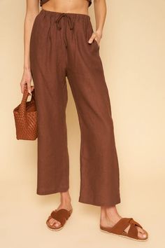 A pull-on style linen pant with drawstring waist line and ever so slightly cropped length that perfectly grazes the ankle. We love this on trend chocolate linen, whether it's paired back to the matching Valentina Top as a set or styled with any of your favorite summer weight tops. Designed and produced in Los Angeles, California. 100% Linen Made in USA Measurements: XS: Waist 24"-28" | Inseam 27.75" S: Waist 26"-30" | Inseam 28" M: Waist 28"-32" | Inseam 28.25" L: Waist 30-34" | Inseam 28.5" XL: Linen Drawstring Pants, Linen Pant, Clothing Sets, Sustainable Clothing, Drawstring Pants, Linen Pants, Los Angeles California, Matilda, Lifestyle Brands