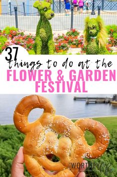 some people are standing in front of the flower and garden festival with sesame characters on it