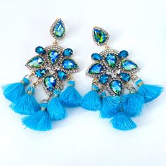 Diamond Encrusted Peacock Inspired Gems and Aqua Tassels make these the earrings to beat.  Flair, style, and you name it.  These will deliver! Turquoise Dangle Tassel Earrings For Party, Turquoise Tassel Earrings For Party, Party Turquoise Tassel Earrings, Bohemian Peacock Design Earrings For Party, You Name It, Grand Prairie, Tassel Earrings, Name It, Jewelry Earrings Dangle