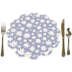 a place setting with silverware and flowers on the tablecloth, along with forks and spoons