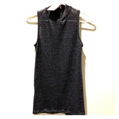 Lightweight Sweater Tank With Silver Detailing That Adds A Sexy Shimmer. This Top Is A Bit Sheer And Can Be Worn With A Bralette/Bandeau/Cami. It Is Tunic Length With Small Slits On The Sides And Can Easily Be Worn With Leggings! Great For A Night Out! Chic Metallic Tops With Shine Detail, Chic Metallic Shine Tops, Glamorous Fitted Tops With Sheen, Sleeveless Shine Tops For Night Out, Chic Tops With Shine For Night Out, Shiny Stretch Top For Party, Chic Shiny Tops For Night Out, Glamorous Shiny Tops For Night Out, Shimmer Stretch Tops For Party