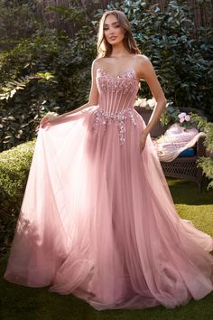 a woman in a pink dress posing for the camera