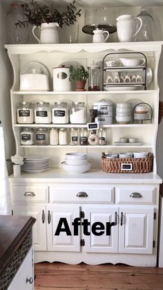 a kitchen with white cupboards and shelves filled with pots, pans and dishes