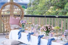 a table set up with flowers and candles for a wedding breakfast or bridal party