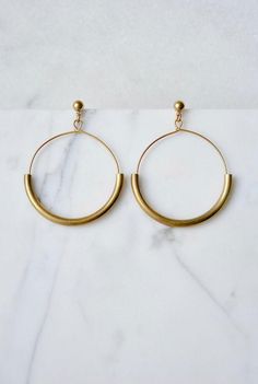 These are a modern take on the simple hoop earring.  Beautiful brass curves rest on handcrafted wire hoops, beneath simple nickel free studs. The design is unique because the wire hoop is free to swing around, so it makes more of a statement, and catches the light beautifully.I get the curves in a brighter gold tone, and then I age them slightly in a darkening solution, giving them a deeper brass tone. ► DETAILS:MEDIUM size: 1 7/8" long x 1 3/8" wide (4.75 cm x 3.5 cm)LARGE size: 2" long x 1 5/8 Minimalist Hoop Metal Jewelry, Modern Metal Open Circle Hoop Earrings, Minimalist Nickel-free Small Hoop Earrings, Minimalist Hoop Earrings With Ear Wire, Modern Gold Hoop Linear Earrings, Minimalist Small Hoop Brass Jewelry, Minimalist Open Circle Hoop Earrings For Everyday, Minimalist Round Brass Earrings, Minimalist Round Linear Earrings For Everyday