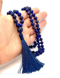 The belief is that the spirit of their gods lived within the stone, while the ancient Egyptians saw it as a symbol of the night sky. Since the earliest of times, lapis lazuli has been associated with strength and courage, royalty and wisdom, intellect and truth. This mala 108 beads is beaded with 8mm natural lapis lazuli and 12 mm big center piece. The length of the necklace is approximated 36-38" not included the tassel of approximated 3" long. Sapphire Beaded Necklaces With Natural Lapis Lazuli Stones, Blue Mala With 8mm Beads For Meditation, Spiritual Beaded Necklaces With Natural Stones For Festivals, Bohemian Hand-strung Lapis Lazuli Jewelry, Lapis Lazuli Amulet Necklace For Healing, Traditional Jewelry With Round Lapis Lazuli Beads, Blue Round Beads Mala For Meditation, Blue 8mm Beads Spiritual Mala, Spiritual Lapis Lazuli Beaded Necklace Gift