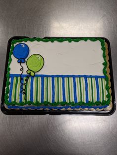 a birthday cake with green and blue decorations