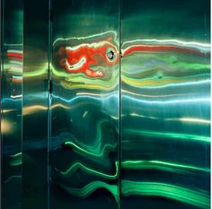 the reflection of an abstract painting on a glass door is seen in this photograph,