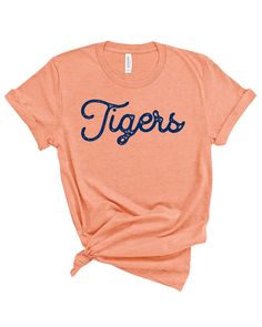 Tigers Stamped Gameday Tee College Varsity T-shirt With Graphic Print, Game Day T-shirt With Logo For Baseball Season, Game Day Baseball T-shirt With Logo Print, Varsity Logo Print T-shirt For Game Day, Game Day T-shirt With Screen Print For Sports Season, Team Spirit T-shirt With Letter Print For Fans, Collegiate Game Day T-shirt With Team Name, Varsity T-shirt With Team Name For College, Varsity Cotton T-shirt For Baseball Season