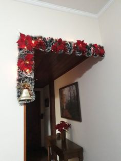 a christmas decoration with lights and poinsettis on the wall