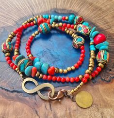 ♥️ Free Shipping ♥️ triple wrap bracelet made from tibetan brass beads ,coral, turquoise and bronze colored beads., with a bronze colored infinity shape bead. It is 22 inches long and can be worn as a necklace as well. Goes round the wrist three times and is suitable for wrist size 6.25-6.75 inches.  Beads:  Tibetan beads and coral nugget beads are approx 7mm / 0.28 inch wide, red beads are 3mm / 0.12 inch wide. Fastens with bronze colored lobster clasp,  Please contact me if you have any questi Turquoise Multi-strand Wrap Bracelet As Gift, Turquoise Wrap Bracelet Gift, Turquoise Wrap Bracelet Great For Gifts, Bohemian Red Bracelet With 108 Beads, Bohemian Turquoise Beaded Bracelets For Festivals, Bohemian Hand-wrapped Bracelets For Festivals, Bohemian Hand Wrapped Beads For Meditation, Festival Gemstone Beads Wrap Bracelet, Spiritual Beaded Turquoise Wrap Bracelet