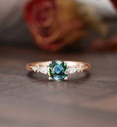 "Engagement ring - center stone:Blue Green Sapphire 5mm round cut - width: approximately 1.5mm  - thickness: approximately 1.3mm Side stone:Moissanite or Diamond - diamond:0.16ct,2*3mm pear cut,Color G-H,Clarity SI-VS - moissanite:0.16ct * Click on the \"Pin It\" icon if you like this item * Custom Order We can make custom rings in almost any shape and style. If you want a specific model, please send us a clear picture and we will do our best.  * Shipping Most items take 3-4 weeks to create.I'm happy to rush your order, fees may apply, write me for details. * Payment Plans I offer payment plans. The minimum per payment will be $100. Write me your finger size, metal color, How much you would like to pay for the first payment. I will create a payment plan which will be customized specially f Sapphire Engagement Ring Round, Flower Halo Engagement Ring, Round Sapphire Engagement Ring, Blue Green Sapphire Engagement Ring, Blue Green Sapphire Ring, Art Deco Sapphire Ring, Vintage Sapphire Ring, Black Onyx Engagement Ring, Green Sapphire Engagement