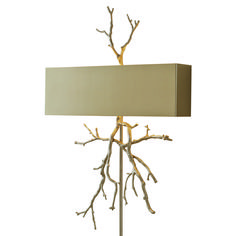 a table lamp with branches on it and a light shade over the base that is off white