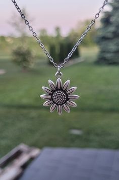 "This necklace has a cute silver sunflower charm.  The charm measures 7/8\" wide.  *Choose your necklace length that check out. The chain is stainless steel.  This will be sent to you in a gift bag or box. This is perfect for anyone! Birthdays, anniversaries, jewelry for bridesmaids, gifts for Mom, or any other occasion. Please contact me if you have any custom requests or questions. Shipping is typically 4 to 6 days in the US, Or you can upgrade to Priority (2 to 3 days) or Express (1 to 2 days). International shipping is between 1 to 3 weeks, depending on your location. You can select an upgrade at checkout." Silver Flower Charm Necklace For Everyday, Silver Charm Necklace With Flower Charm For Everyday, Silver Everyday Charm Necklaces With Flower Charm, Everyday Silver Charm Necklace With Flower, Silver Hypoallergenic Flower Necklace, Silver Sunflower Pendant Necklace, Silver Sunflower Design Flower Necklace, Silver Sunflower Design Necklace, Silver Sunflower Design Necklace For Gift