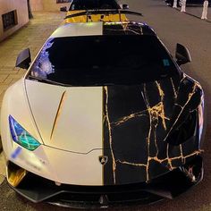 two sports cars parked side by side on the street