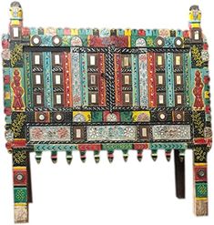 an artisticly designed bench made out of wood and painted with colorful designs on it